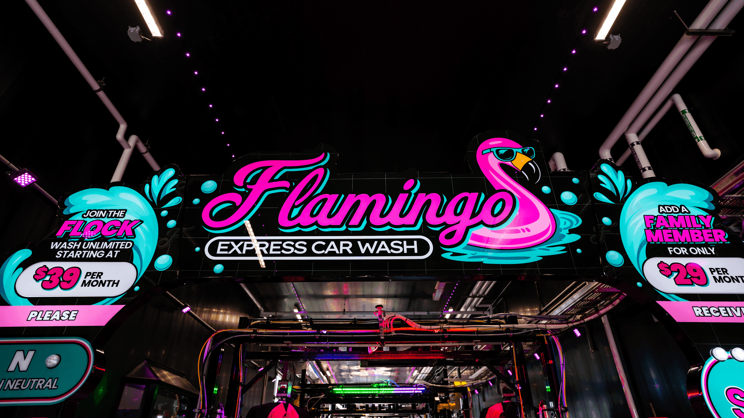 The neon-lit tunnel entrance at Flamingo Express Car Wash